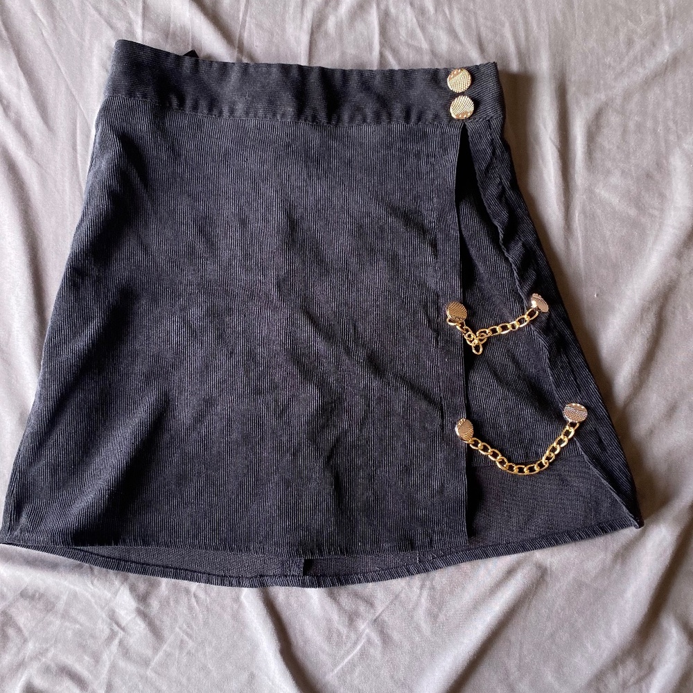 Black skirt with gold chain accessories